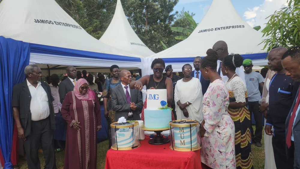 Guests gather around the launch cake